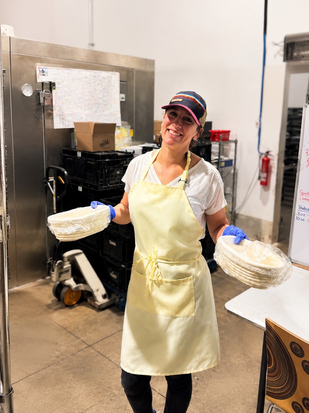 Kara in the commercial kitchen with proofing baskets