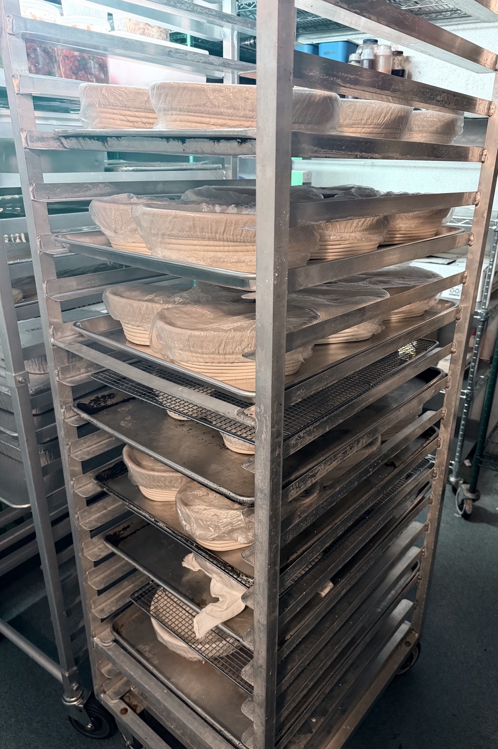Sourdough loaves proofing on racks